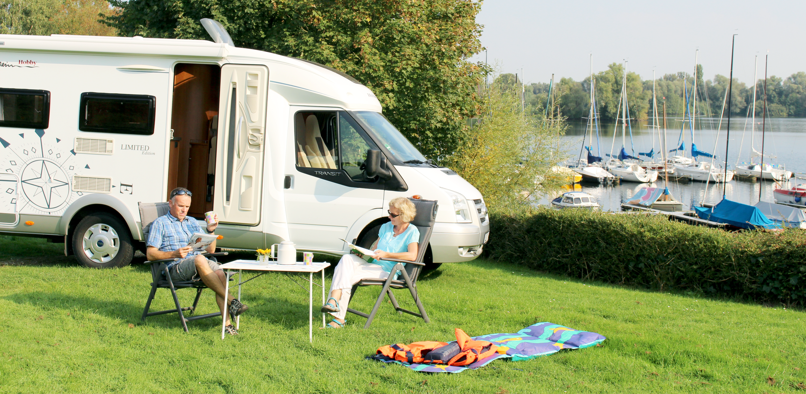 Senior couple enjoying some lunch near a boat marina.